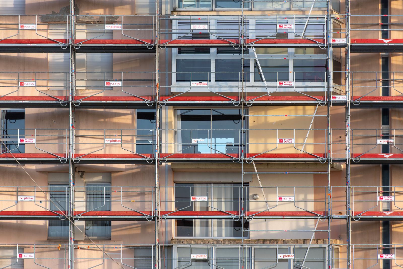 Scaffolding covers an urban building facade