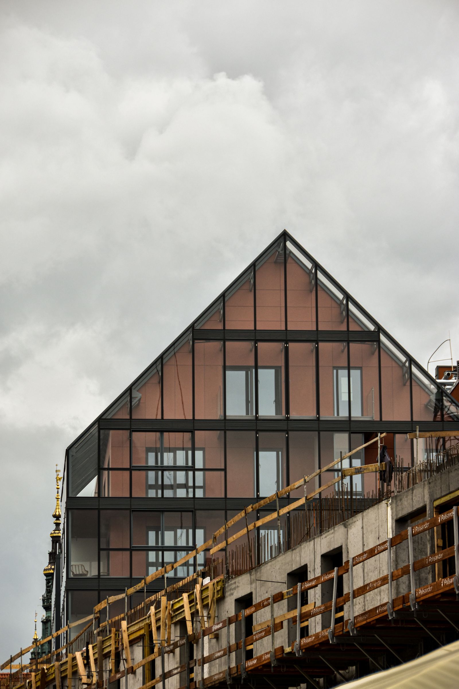 Glass-faced building under construction photographed from street level