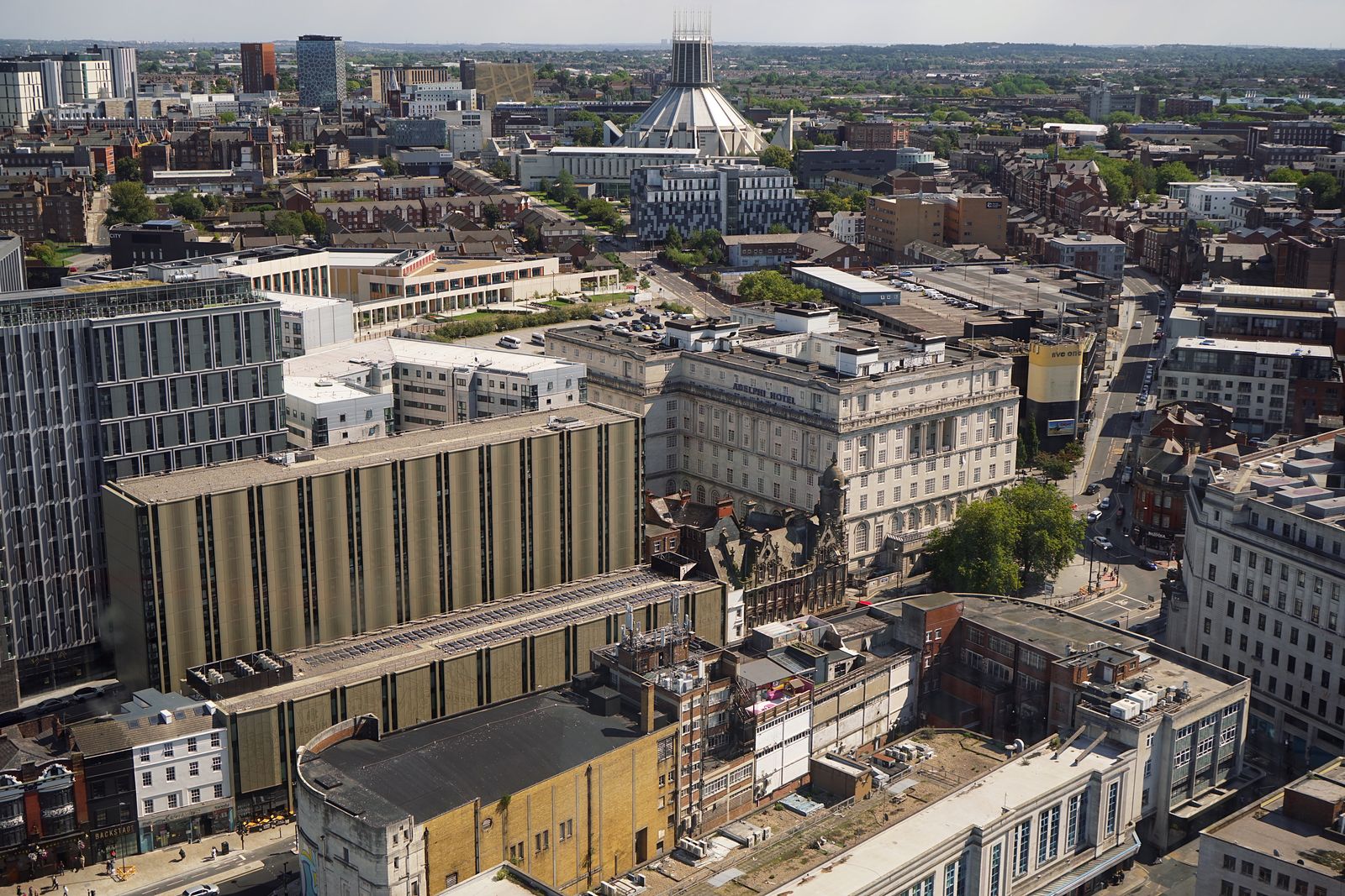 Elevated city view across buildings, streets and rooftops with Liverpool's Metropolitan Cathedral in the distance