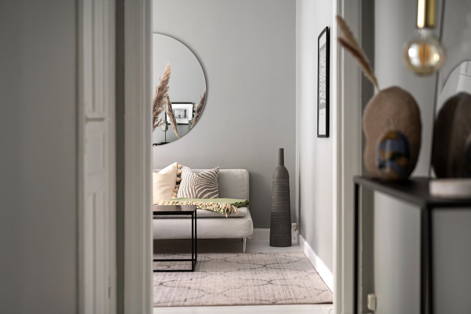 Living room with sofa and carpet seen through a doorway