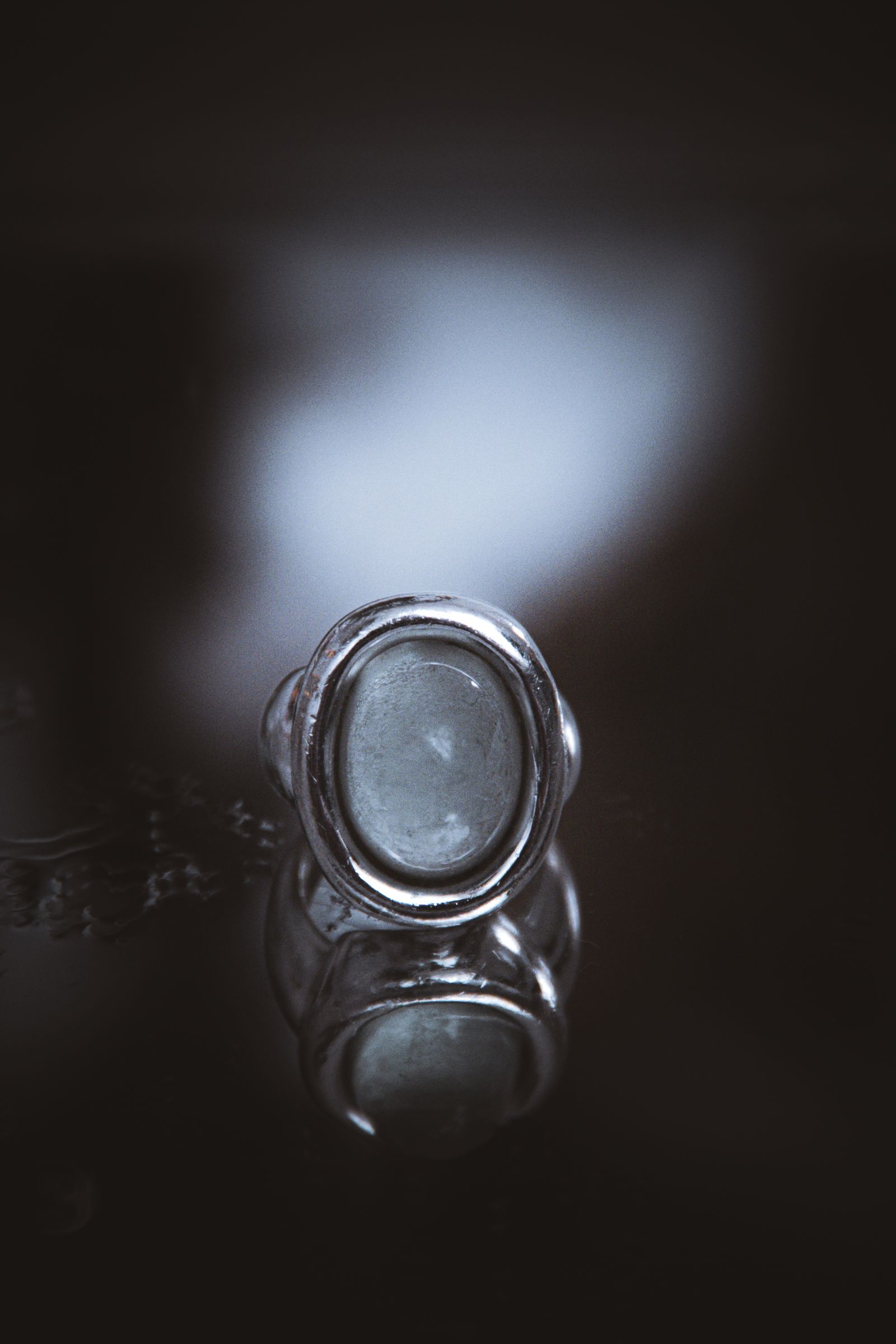 Close view of a gemstone ring and its reflective mounting