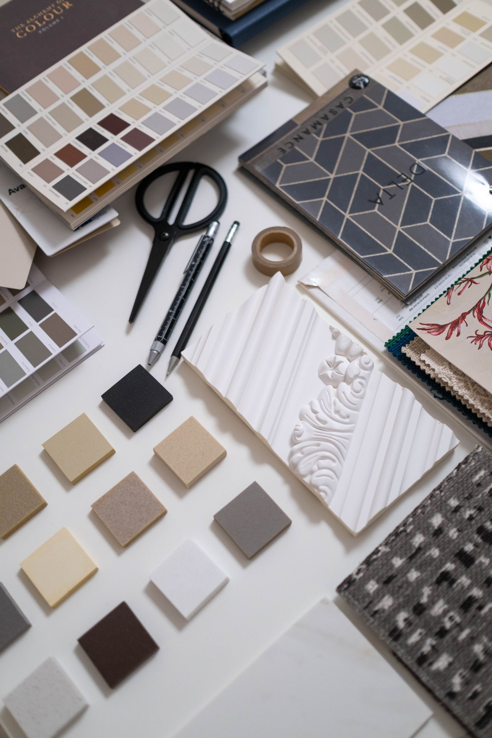 Paint charts, fabric swatches, molding samples and small finish samples arranged on a design table