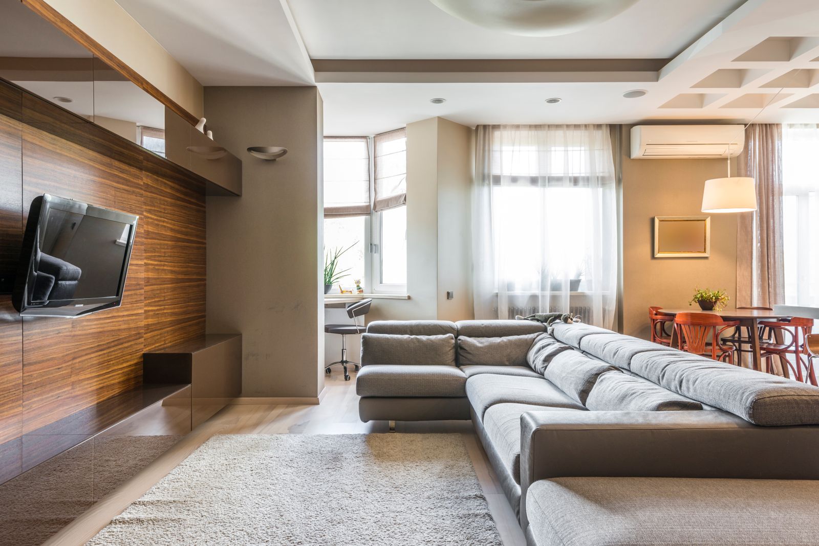 Bright living room with a large sofa and windows
