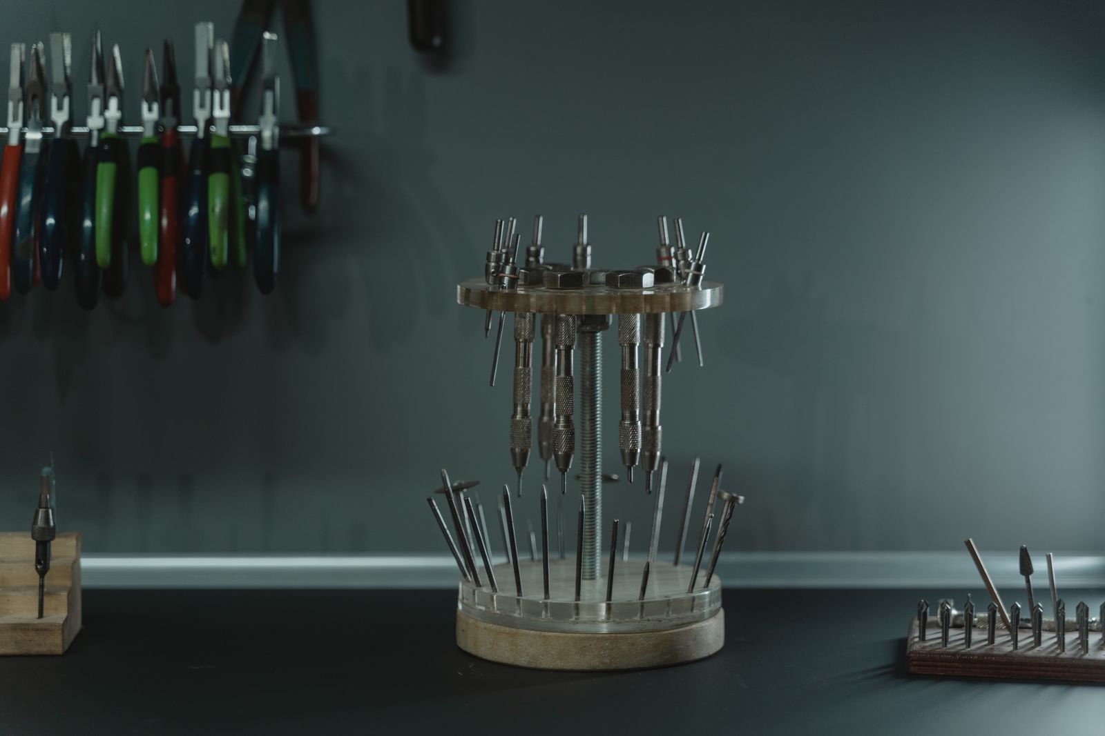 Tools and small supplies arranged on a jewelry workbench