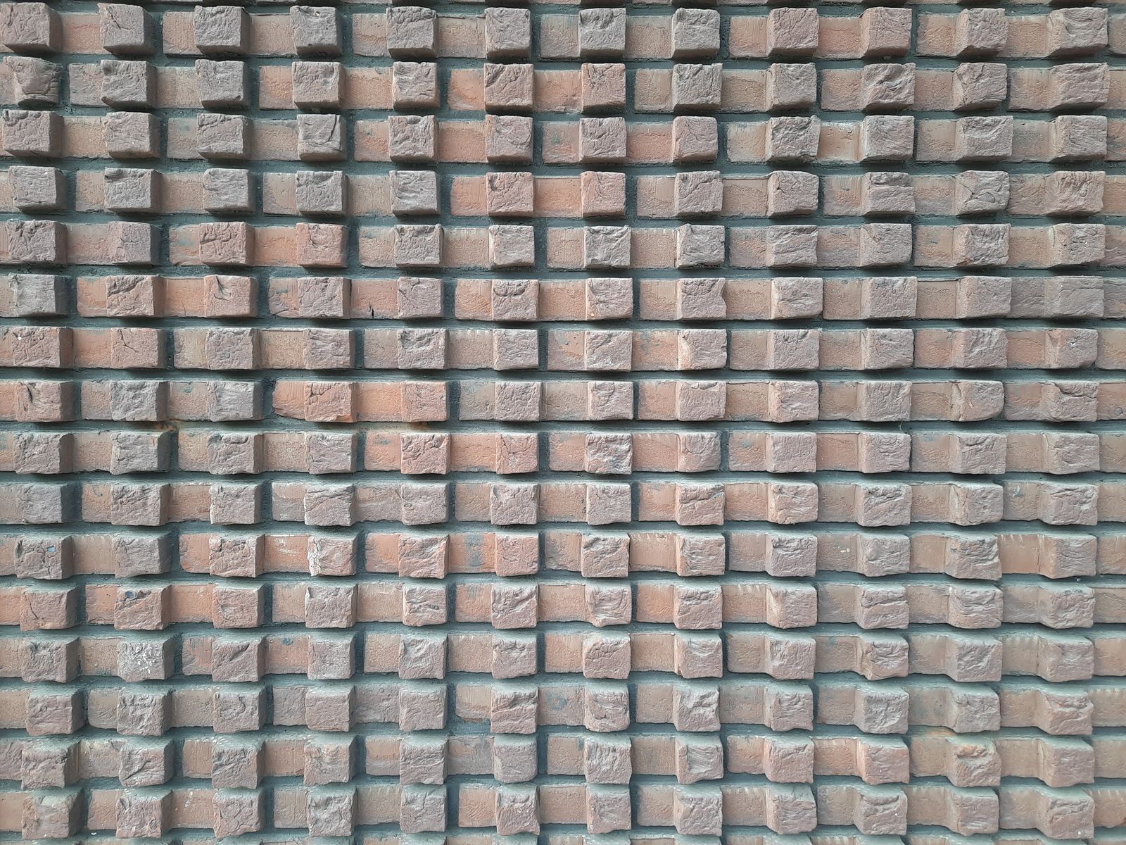 Brick wall with repeated rectangular units and visible mortar joints