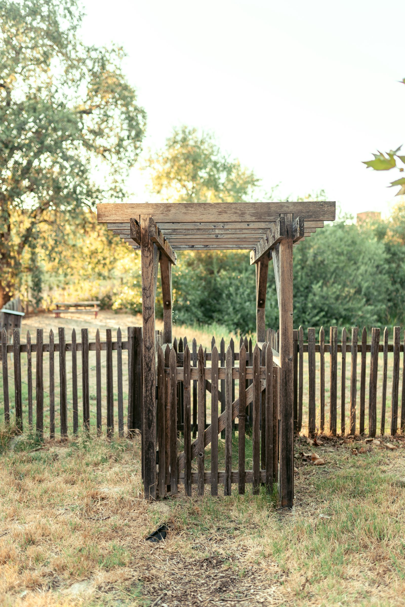 Wooden fence sections and a gate in a rural setting