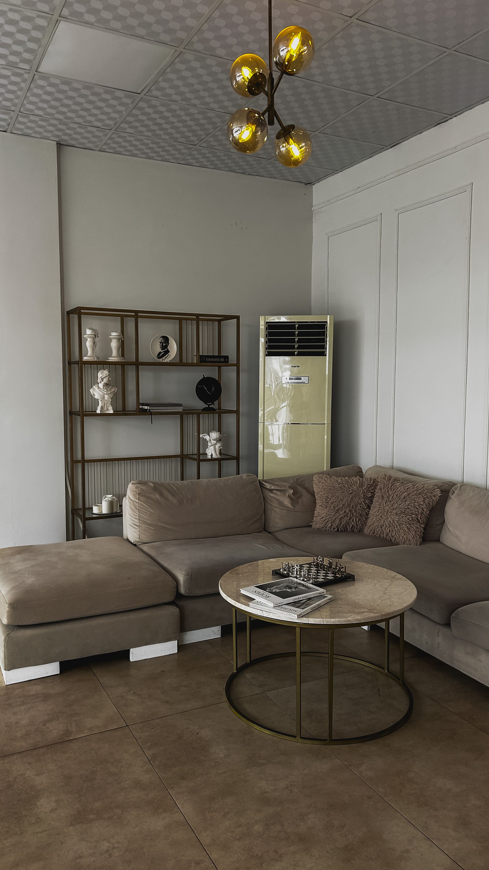 Gray sectional sofa and a round table in a furnished living room