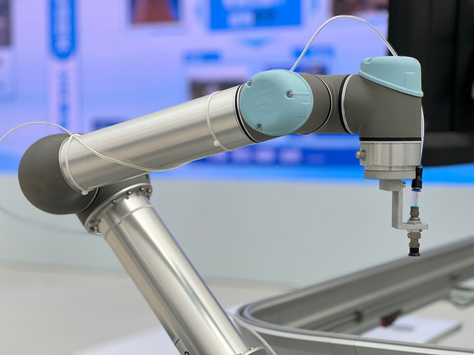 Close view of an industrial robotic arm and its connected mechanical end assembly