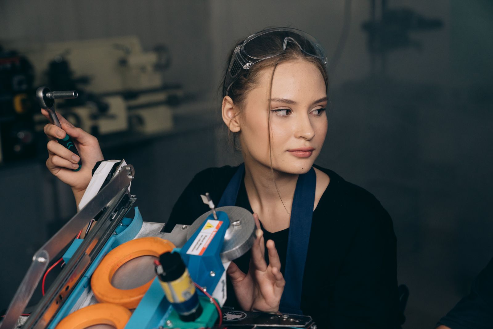 Engineer adjusts equipment inside an industrial workshop