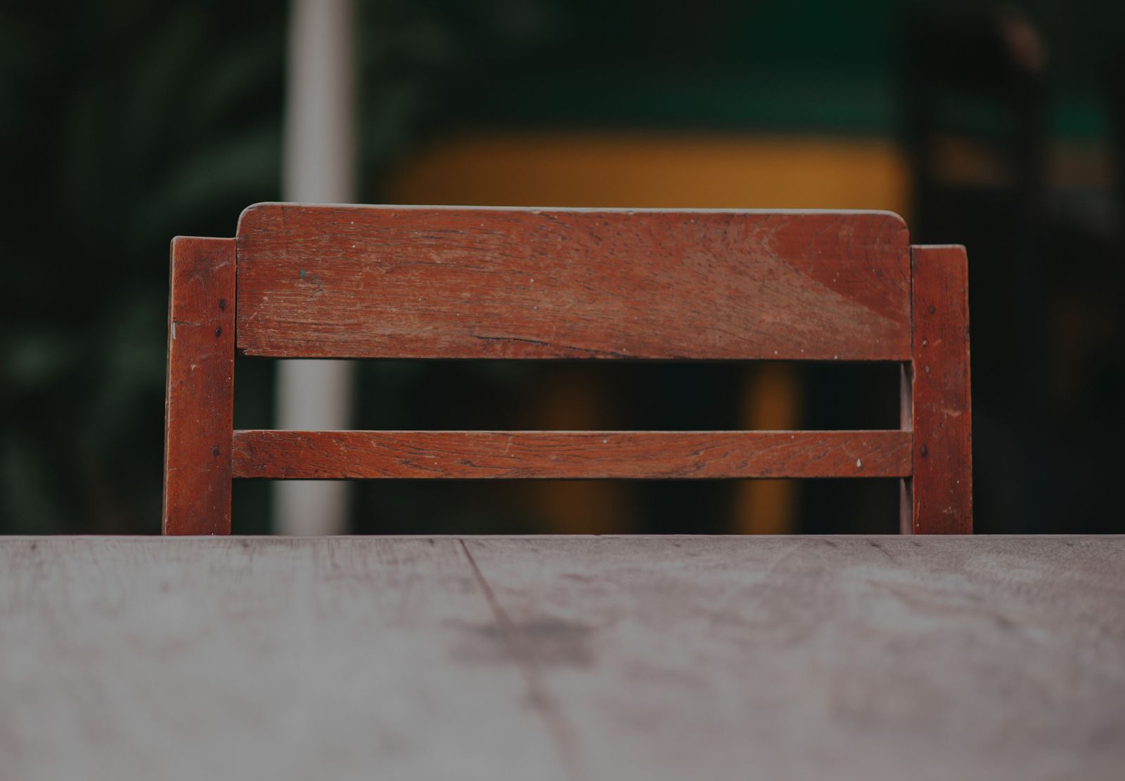 Close view of a wooden chair beside a wooden table